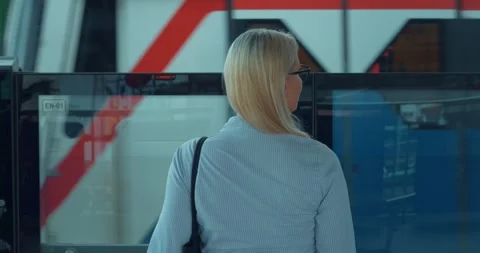 Woman in subway, moving train, back view. Female student waiting for train to Stock Footage 257540831