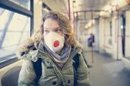 Woman In Subway With Respirator On Her Head Like A Passenger. Protection Against Stock Photos