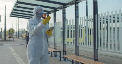 Woman with suitcase having temperature checking near airport. Medical worker in Video stock 131422830