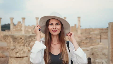 Woman in summer hat looking at camera among old temple Stock Footage 166633744