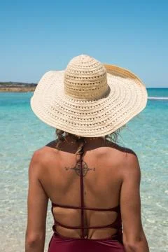 Woman in Sun Hat looking toward Tropical Water Stock Photos