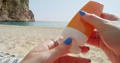 Best friends applying sunscreen girl rubbing suntan lotion on back
