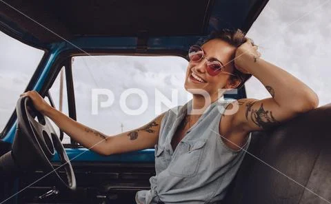 Woman with sunglasses driving a car. Stock Photos