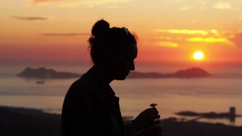 A woman with the sunset in the background. Stock Footage 148791390