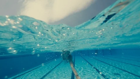 Woman swim the front crawl in an olympic pool day sunny slow motion  Stock Footage