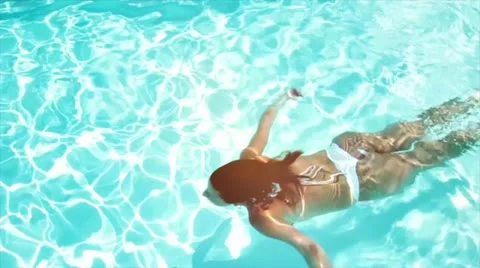 Woman swimming in pool Stock Footage
