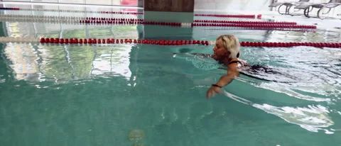 A woman is swimming in a pool. Stock Footage 281865501