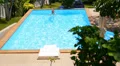 Woman Swimming in the Resort Outdoor Pool. Sunny Summer Landscape. HD Footage
