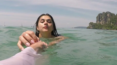 Woman Swimming In Sea Water Hold Man Hand POV, Young Couple Tourists Group Stock Footage