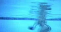 Woman swims to far deep end of pool HD Footage