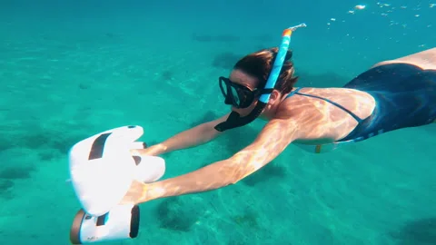 Woman swims using modern innovative diving gadget, underwater scooter. Stock Footage 268625361