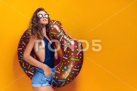 Woman in swimsuit with swim ring Stock Photos