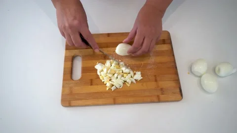 Woman on the table cutting eggs Stock Footage 234768080