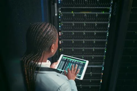 Woman, tablet and coding with maintenance in server room for cybersecurity Stock Photos