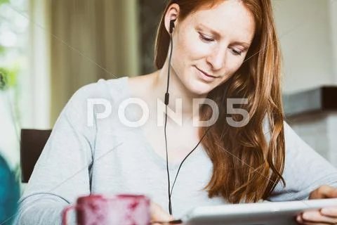 Woman with Tablet and Headphones Stock Photos