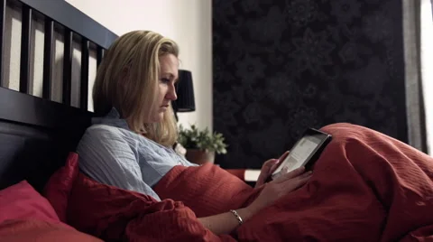 Woman with tablet in bed. Video stock 42175949