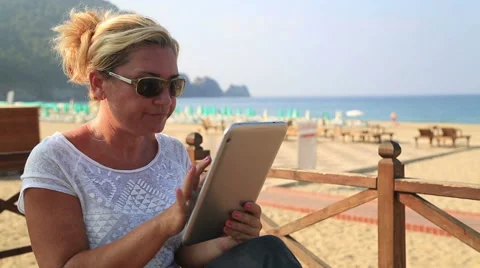 Woman with tablet computer on the beach Stock Footage 41472986