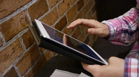 Woman on Tablet Computer in Cafe 50p tight shot Stock Footage 47192040