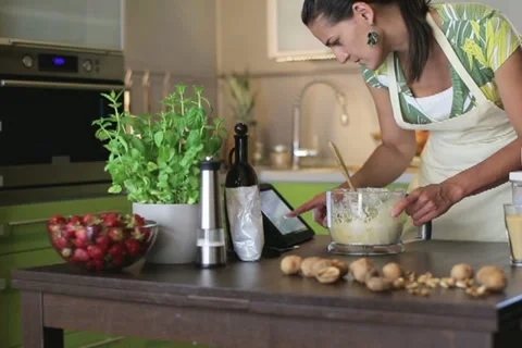 Woman with tablet computer preparing a cake in the kitchen 스톡 동영상 11615036