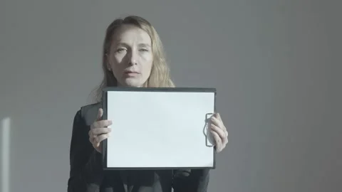 A woman with a tablet in her hands on which a white sheet of paper is attached. Stock Footage 232998285