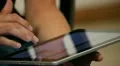 A woman with tablet on legs (close-up) HD Footage