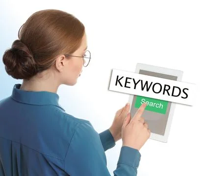 Woman with tablet searching for keywords on white background Stock Photos