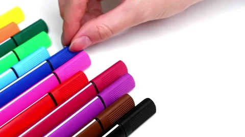 The woman takes a blue marker from a stack of colored marker. Stock Footage 157492933