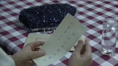 Woman takes note from envelope Stock Footage 249511885
