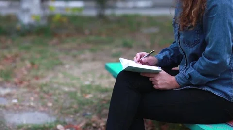 Woman Takes Notes in a Notebook Stock Footage 56302325