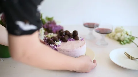 Woman taking and returning back raw vegan cheesecake with chocolate balls Stock Footage 88730411