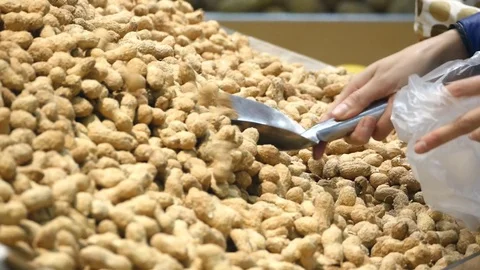 Woman taking araxis nuts Stock Footage 71933527