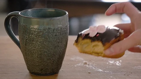 Woman Taking a Bite From a Chocolate Glazed Donut Stock Footage 106157243