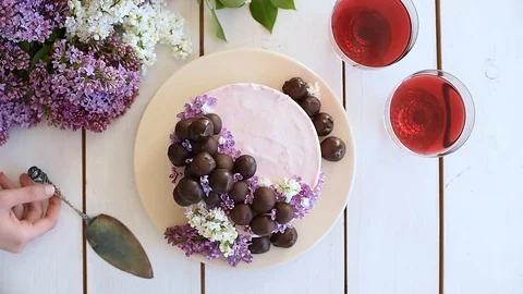 Woman taking the cake server from a scene with raw vegan cheesecake Stock Footage 88730412