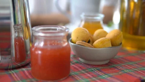 Woman taking cake while drinking tea, close up. Tea pot, honey, jam, cakes. Stock Footage 88663387