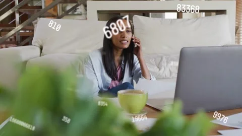 Woman taking call while scanning documents, animated data overlay highlighting Stock Footage 333774469
