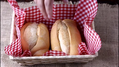 Woman taking french bread with hand from basket at breakfast Stock Footage 291450341