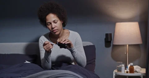 Woman taking medication on bed Stock Footage 194141253