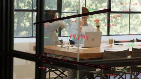Woman taking notes and man reviewing laptop, spotting ticker overlay and Stock Footage 333034664