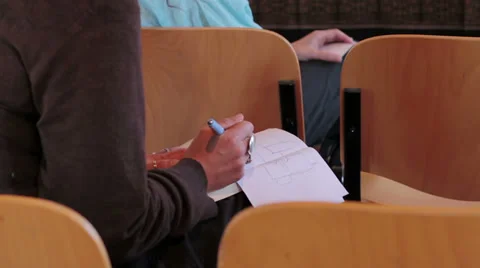 Woman is taking notes by hand on block notes: conference, audience, press Stock Footage 28204956