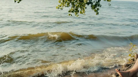 Woman taking notes in a notebook sitting on the coast 스톡 동영상 65824802