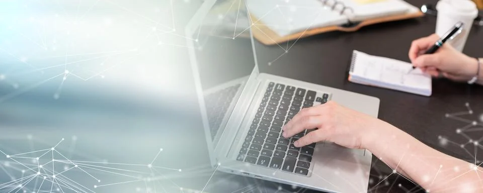 Woman taking notes while using laptop; panoramic banner Foto stock