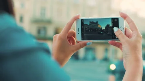 Woman taking photo of building. View over shoulder. Back view. Woman making Stock Footage