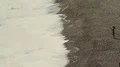 Woman taking photo of powerful sea waves splashing on beach, slow-motion HD Footage