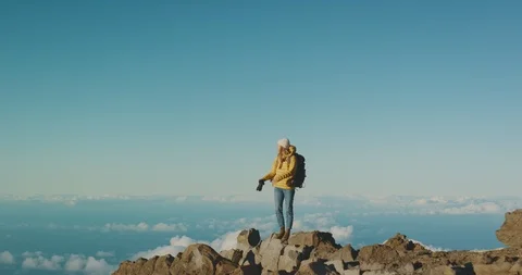 Woman taking photos above the clouds Stock Footage 125160271