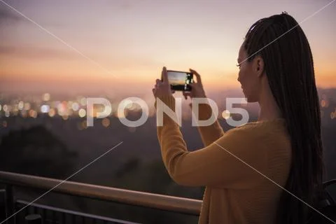 Woman taking picture of a modern city Stock Photos
