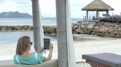 Woman taking selfie with tablet while enjoying vacation in tropical resort. Stock Footage 52482406