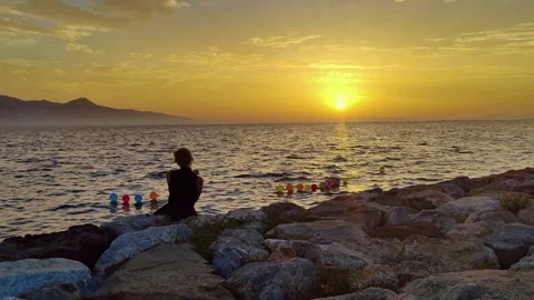 Woman Taking Selfie While Sitting on the Beach and Watching the Sunset Stock Footage 279409604
