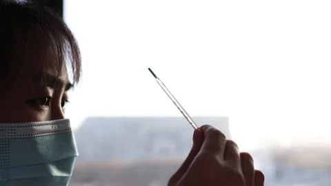 Woman taking temperature when sick Stock Footage 259393235