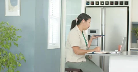 Woman is taking work call, speaking while using laptop and notes, cheering at Stock Footage 344851116