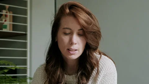 Woman talking and looking down Video stock 130643254